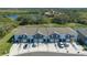 Aerial view of new townhomes featuring attached garages and well-kept landscaping in a peaceful setting at 8612 Milestone Dr, Sarasota, FL 34238