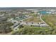 Aerial view of the community and surrounding area featuring a pond and lush greenery at 8612 Milestone Dr, Sarasota, FL 34238