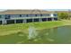 Townhouse with a serene pond view and water fountain feature in the backyard at 8612 Milestone Dr, Sarasota, FL 34238