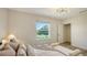 Comfortable bedroom with a view of the lawn and pond featuring a fountain at 8612 Milestone Dr, Sarasota, FL 34238