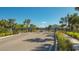 Gated community entrance with well-maintained landscaping and clear road markings at 8612 Milestone Dr, Sarasota, FL 34238
