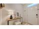 Inviting entryway featuring stylish decor, a side table and a complementary bench seating at 8612 Milestone Dr, Sarasota, FL 34238