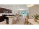 Stylish kitchen featuring a breakfast bar, granite countertops, stainless appliances, and open floor plan at 8612 Milestone Dr, Sarasota, FL 34238