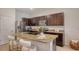 Modern kitchen featuring granite countertops, stainless steel appliances, and sleek, dark cabinets at 8612 Milestone Dr, Sarasota, FL 34238
