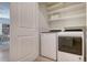 Well-organized laundry room with modern appliances and plenty of shelving for storage at 8612 Milestone Dr, Sarasota, FL 34238