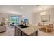 Open-concept living area with a modern kitchen island, dining space, and bright living room at 8612 Milestone Dr, Sarasota, FL 34238