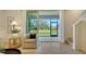Bright living room with tile floors, patio doors to the outside, and a view of the water at 8612 Milestone Dr, Sarasota, FL 34238