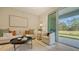 Inviting living room with comfortable seating, decorative accents, and sliding doors to the outdoors at 8612 Milestone Dr, Sarasota, FL 34238
