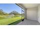 Covered patio offering a relaxing view of the lush green lawn and tranquil pond with a fountain at 8612 Milestone Dr, Sarasota, FL 34238