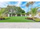 Manicured common area featuring lush green grass, decorative plantings and seating at 9641 Carnoustie Pl, Bradenton, FL 34211