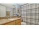 Bathroom featuring a granite vanity, framed mirror and a shower with a striped curtain at 966 La Costa Cir # 1, Sarasota, FL 34237