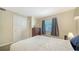 This bedroom offers natural light, soft carpeting, and a neutral palette for a soothing and relaxing retreat at 966 La Costa Cir # 1, Sarasota, FL 34237