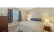 Calm bedroom offers soft lighting, cozy carpeting, and dark curtains for a serene and restful ambiance at 966 La Costa Cir # 1, Sarasota, FL 34237