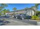 Exterior view of condo building with parking space and stairwells leading to the units at 966 La Costa Cir # 1, Sarasota, FL 34237