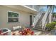 Inviting condo exterior with staircase leading to the upper level and lush landscaping at 966 La Costa Cir # 1, Sarasota, FL 34237