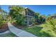 Exterior of the two-story condo with screened lanai and lush landscaping at 966 La Costa Cir # 1, Sarasota, FL 34237
