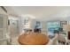Open-concept living room area with dining table and natural light at 966 La Costa Cir # 1, Sarasota, FL 34237