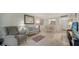 Bright living room features neutral colors, comfortable seating and flows into the dining area, perfect for entertaining guests at 966 La Costa Cir # 1, Sarasota, FL 34237