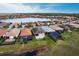 Beautiful aerial view of home with lake, fountain, well-manicured lawns and a view of the community at 11679 Renaissance Blvd, Venice, FL 34293