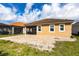 Back view of the home showcasing the brick patio and screened-in porch at 11679 Renaissance Blvd, Venice, FL 34293