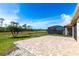 A beautiful brick back patio with a view of the serene pond and golf course at 11679 Renaissance Blvd, Venice, FL 34293