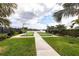 Bocce ball courts with view of lake, fountain, benches and lush vegetation at 11679 Renaissance Blvd, Venice, FL 34293
