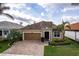 Charming single-Gathering home with a two-car garage, tile roof, and well-manicured landscaping at 11679 Renaissance Blvd, Venice, FL 34293