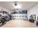 Spacious garage featuring ample storage cabinets, workbench area, and motorcycle at 11679 Renaissance Blvd, Venice, FL 34293