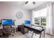 Cozy home office featuring two desk areas, a ceiling fan, and a large window at 11679 Renaissance Blvd, Venice, FL 34293