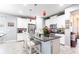 Modern kitchen features white cabinets, stainless steel appliances, and granite countertops with barstool seating at 11679 Renaissance Blvd, Venice, FL 34293
