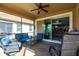 Inviting outdoor lanai with comfortable seating, ceiling fan, and a view of the interior living space at 11679 Renaissance Blvd, Venice, FL 34293