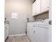 This practical laundry room is equipped with a washer, dryer, and utility sink at 11679 Renaissance Blvd, Venice, FL 34293