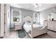 Inviting main bedroom featuring wood tile flooring, trey ceilings, and a large window at 11679 Renaissance Blvd, Venice, FL 34293