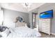 Spacious main bedroom featuring trey ceilings, wood tile flooring, and a large dresser with mirror at 11679 Renaissance Blvd, Venice, FL 34293