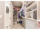 This walk-in closet has custom shelving for organizing clothes, shoes, and accessories at 11679 Renaissance Blvd, Venice, FL 34293