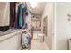 This walk-in closet features custom organizers, shelving, and plenty of room for storage at 11679 Renaissance Blvd, Venice, FL 34293