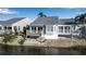 Charming home featuring a deck overlooking the waterfront and an awning for shaded outdoor enjoyment at 1272 Spoonbill Landings Cir, Bradenton, FL 34209