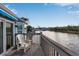 Relax on the deck with a lovely water view, accessible through sliding glass doors and furnished with a comfortable chair at 1272 Spoonbill Landings Cir, Bradenton, FL 34209