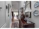 Elegant hallway featuring hardwood floors, decorative wall art, and sophisticated furnishings at 1272 Spoonbill Landings Cir, Bradenton, FL 34209