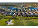 Aerial view of golf community featuring single-Gathering homes and picturesque waterfront views at 15520 Castle Park Ter, Lakewood Ranch, FL 34202