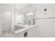 Bright bathroom featuring a dual vanity with marble floors and a glass shower at 15520 Castle Park Ter, Lakewood Ranch, FL 34202