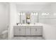 Bright bathroom featuring a dual vanity with marble floors and a glass shower at 15520 Castle Park Ter, Lakewood Ranch, FL 34202