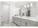 Bright bathroom featuring a dual vanity with marble floors at 15520 Castle Park Ter, Lakewood Ranch, FL 34202