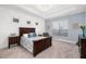 Spacious bedroom featuring a tray ceiling, carpet floors, and view of the outside at 15520 Castle Park Ter, Lakewood Ranch, FL 34202