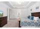 Comfortable bedroom featuring a tray ceiling, and a view to the bathroom at 15520 Castle Park Ter, Lakewood Ranch, FL 34202