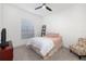 Bright bedroom featuring a bed with a patterned headboard and a window at 15520 Castle Park Ter, Lakewood Ranch, FL 34202