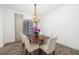 Elegant dining room featuring wood floors, a chandelier, and a window with natural light at 15520 Castle Park Ter, Lakewood Ranch, FL 34202