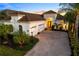 Elegant home with a three-car garage, tile roof, paved driveway, and lush landscaping at 15520 Castle Park Ter, Lakewood Ranch, FL 34202
