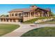 View of the clubhouse exterior featuring a stunning event space and beautiful landscaping at 15520 Castle Park Ter, Lakewood Ranch, FL 34202