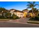 Beautifully landscaped home features a paver driveway and lush tropical landscaping with a barrel tile roof at 15520 Castle Park Ter, Lakewood Ranch, FL 34202